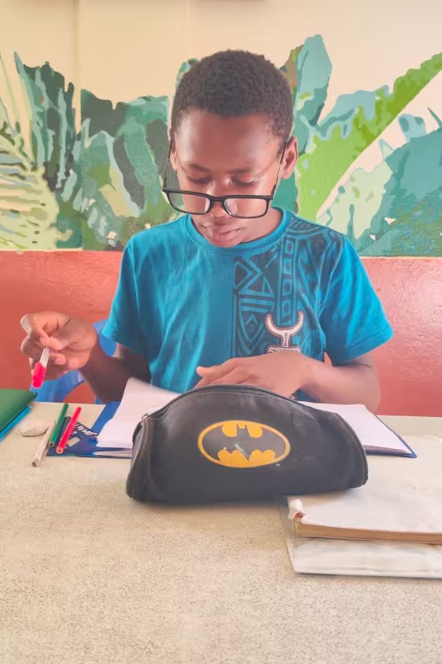 Un collégien de Malaza prépare ses affaires avant de commencer ses devoirs